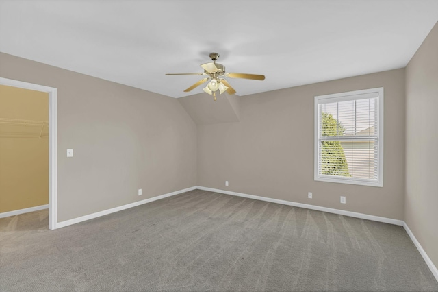 empty room featuring carpet floors, lofted ceiling, and ceiling fan