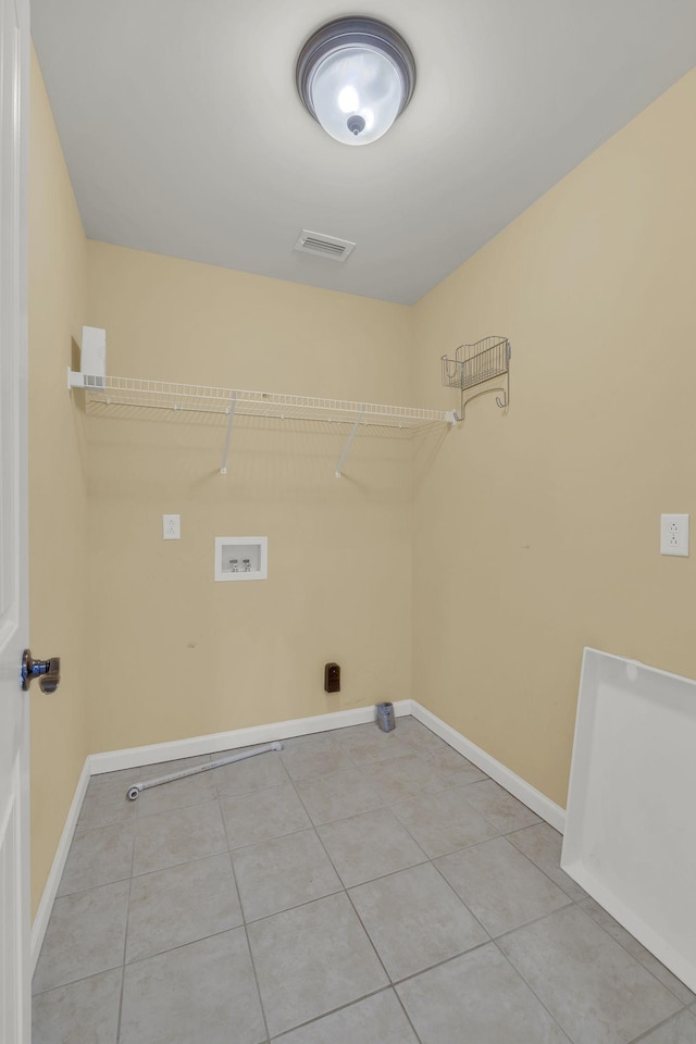 laundry room with washer hookup and tile patterned floors