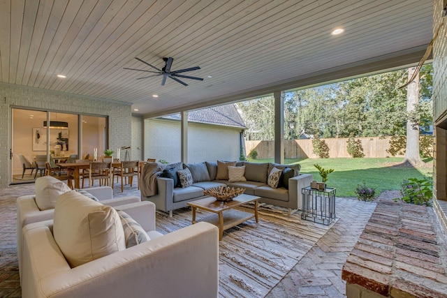 sunroom with ceiling fan and wood ceiling