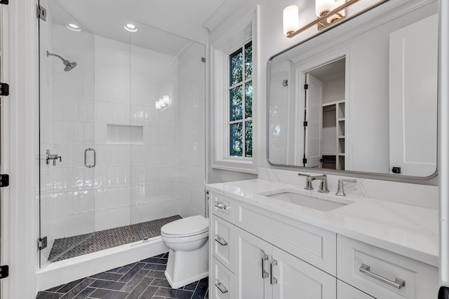 bathroom featuring tile patterned floors, an enclosed shower, vanity, and toilet