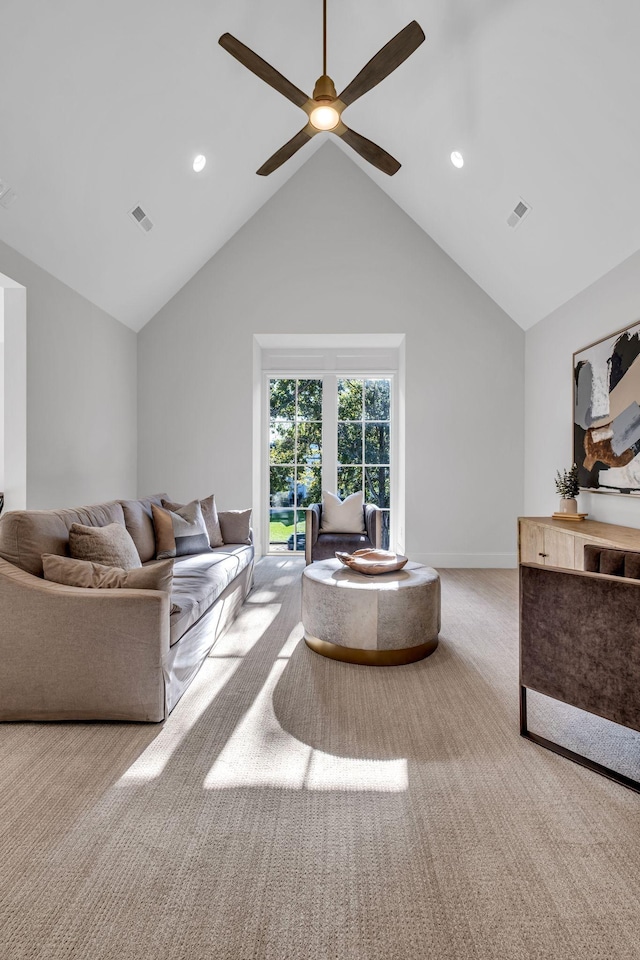 living room featuring ceiling fan, light carpet, and vaulted ceiling