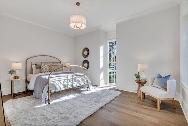 bedroom with crown molding and hardwood / wood-style flooring