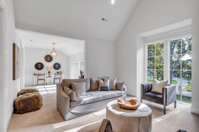 carpeted living room featuring lofted ceiling