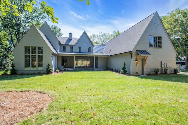 rear view of property featuring a yard