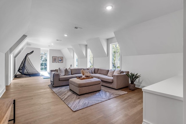 living room featuring vaulted ceiling and light hardwood / wood-style floors