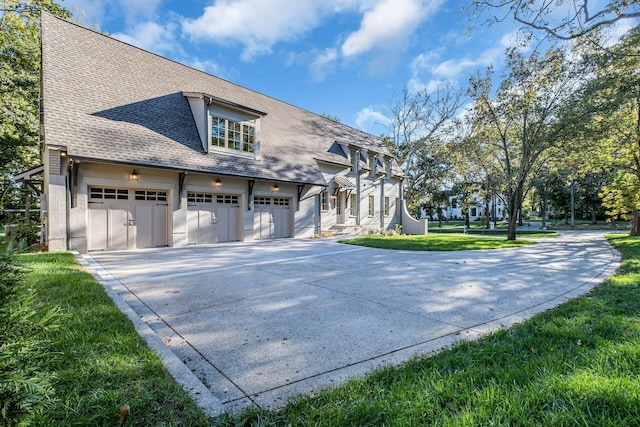 view of front of property featuring a garage and a front lawn