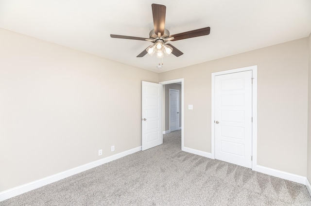 unfurnished bedroom with ceiling fan and carpet