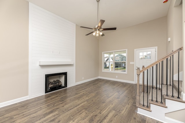 unfurnished living room with ceiling fan, a fireplace, dark hardwood / wood-style flooring, and high vaulted ceiling