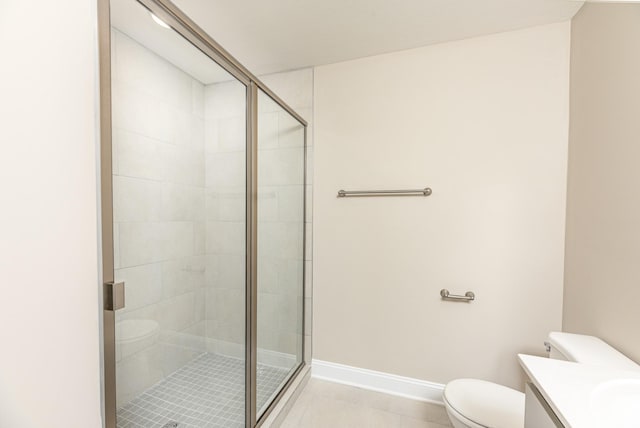 bathroom with toilet, vanity, and an enclosed shower