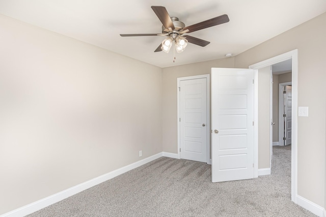 unfurnished bedroom with ceiling fan and light colored carpet