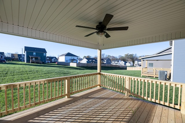 deck featuring ceiling fan, a yard, and central AC unit