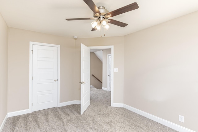 unfurnished bedroom with ceiling fan and light colored carpet