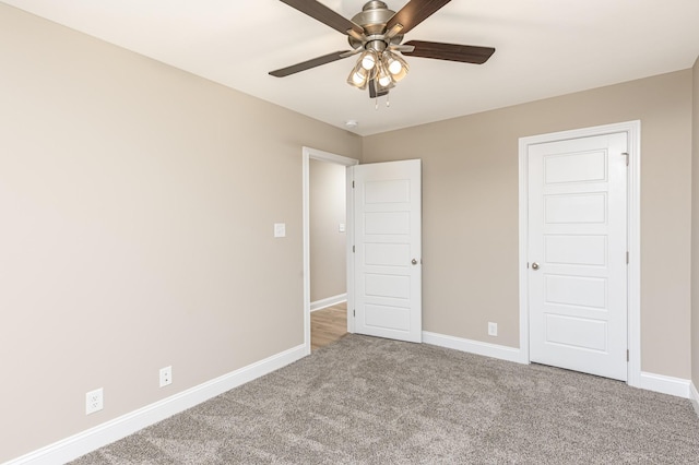 unfurnished bedroom with ceiling fan and light carpet