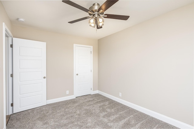 unfurnished bedroom with ceiling fan, carpet floors, and a closet