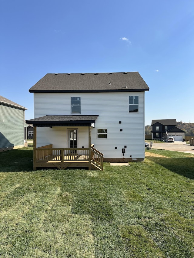 back of house with a wooden deck and a yard