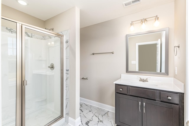 bathroom featuring vanity and a shower with shower door