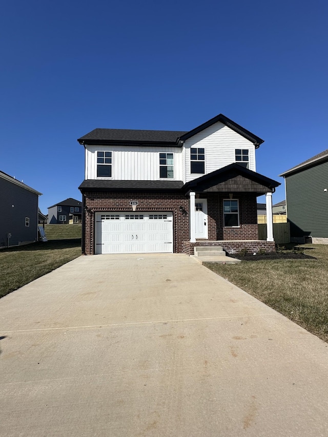 view of front facade featuring a garage, a front lawn, and covered porch