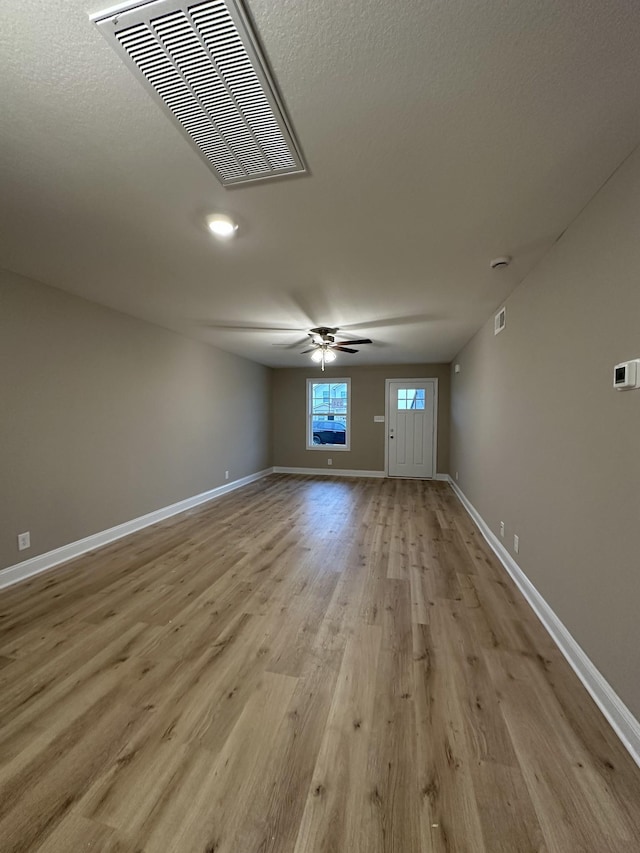 spare room with ceiling fan and light hardwood / wood-style floors