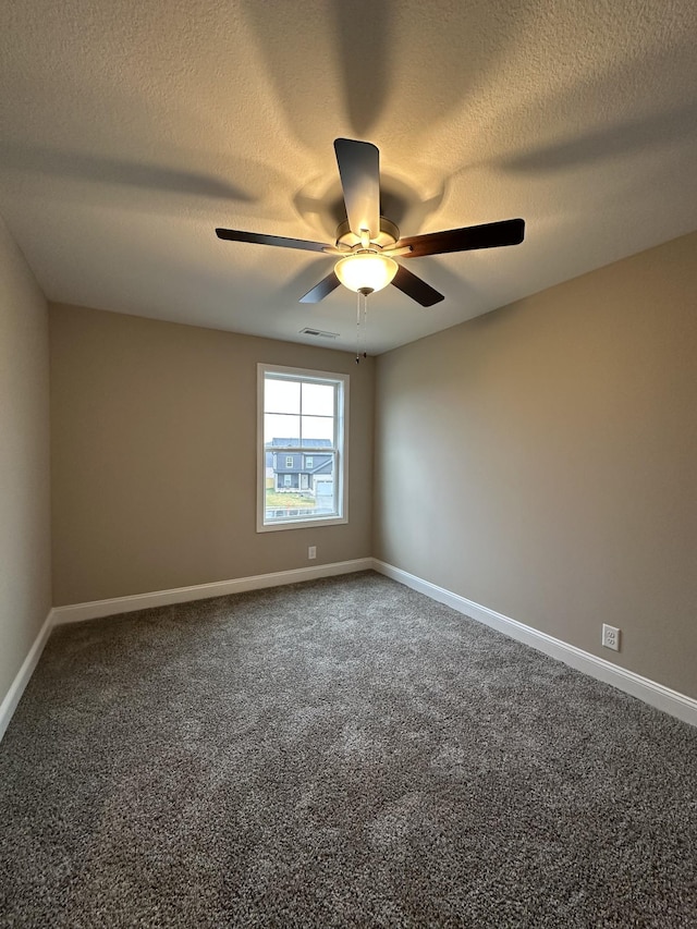 carpeted empty room featuring a textured ceiling and ceiling fan