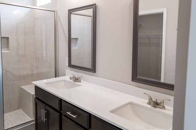 bathroom featuring an enclosed shower and vanity