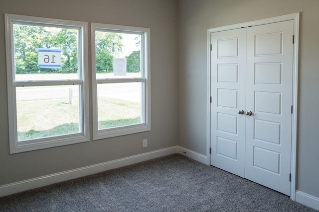 unfurnished bedroom featuring a closet and carpet flooring