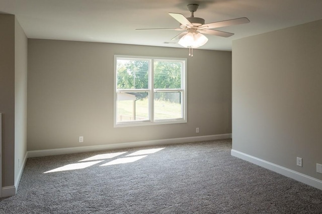 carpeted spare room featuring ceiling fan