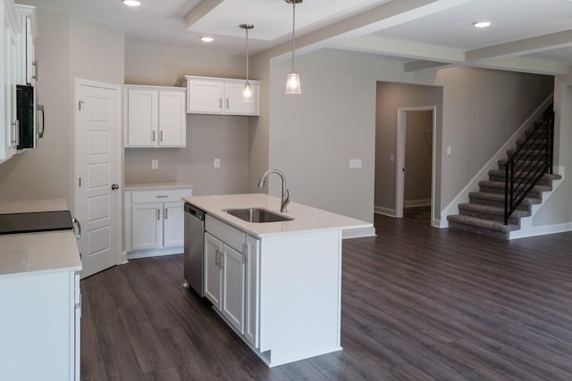 kitchen featuring pendant lighting, sink, a kitchen island with sink, appliances with stainless steel finishes, and white cabinets