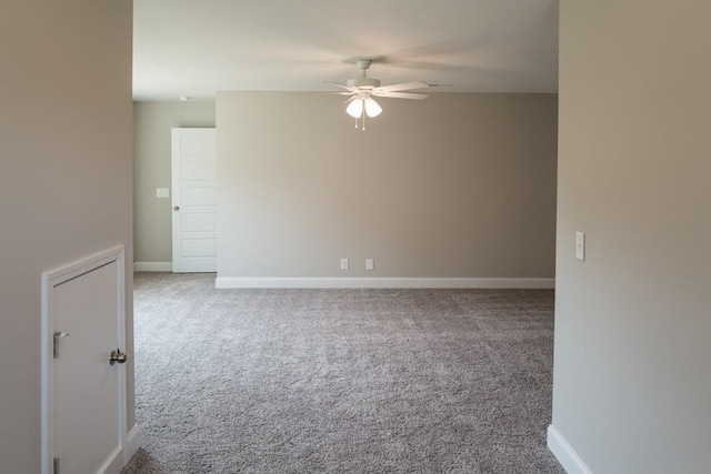 carpeted empty room featuring ceiling fan