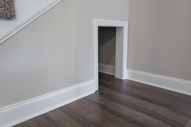 empty room with dark wood-type flooring