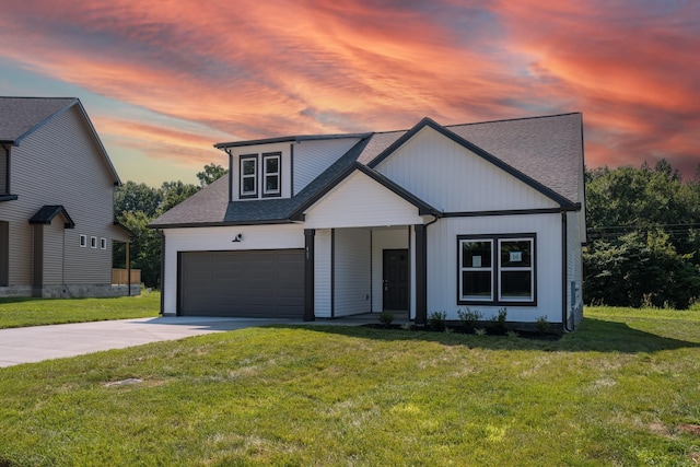 view of front facade featuring a lawn and a garage