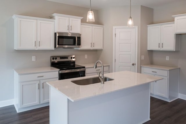 kitchen featuring white cabinetry, a center island with sink, stainless steel appliances, hanging light fixtures, and sink