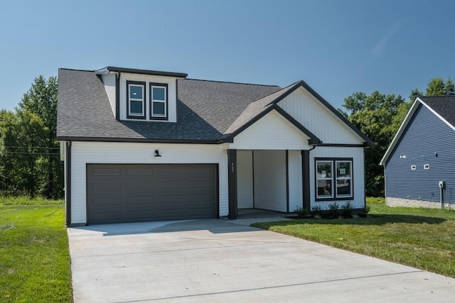 view of front of house with a front yard and a garage