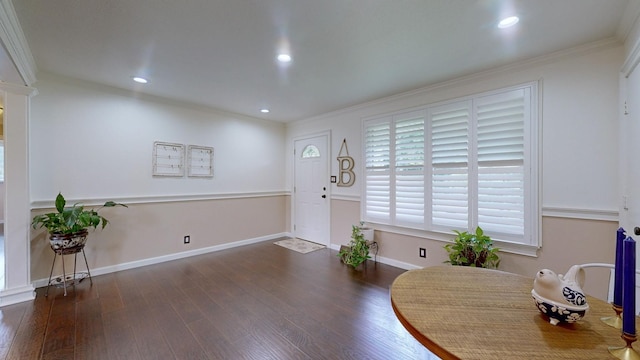 interior space with dark hardwood / wood-style floors and crown molding