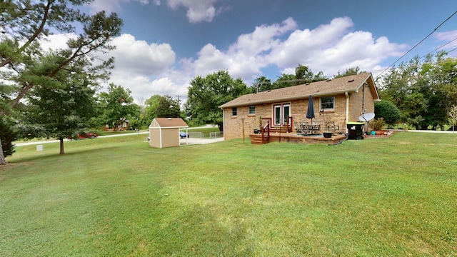 back of property with a yard and a shed