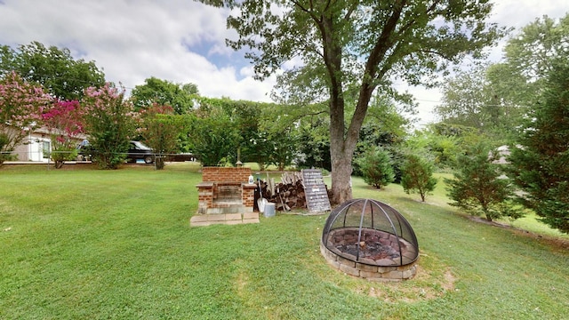 view of yard featuring an outdoor fire pit