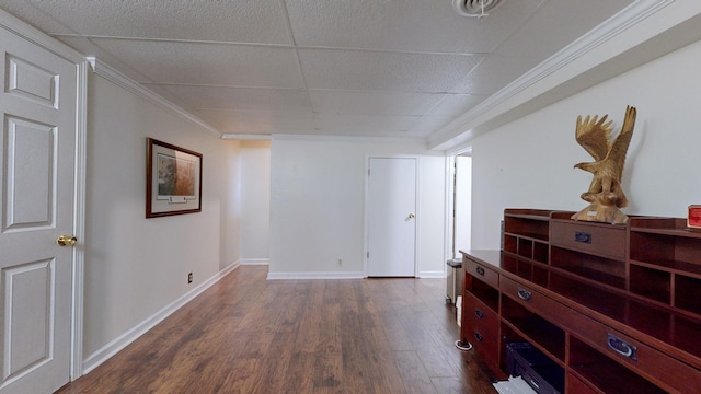 hall featuring a paneled ceiling, crown molding, and dark hardwood / wood-style floors