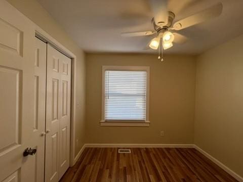 spare room featuring ceiling fan and dark hardwood / wood-style floors