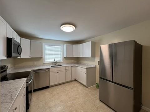 kitchen with sink, white cabinetry, and stainless steel appliances