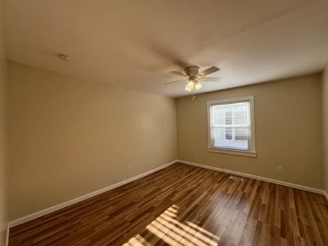 unfurnished room featuring ceiling fan and dark hardwood / wood-style flooring