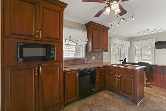 kitchen with black appliances, kitchen peninsula, plenty of natural light, and sink