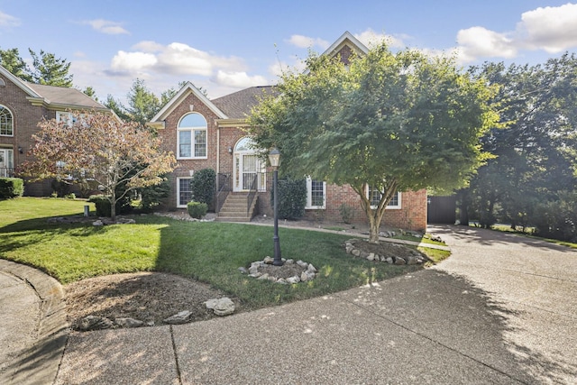 obstructed view of property with a front lawn