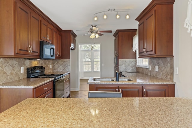 kitchen with black appliances, tasteful backsplash, sink, light tile patterned flooring, and ceiling fan