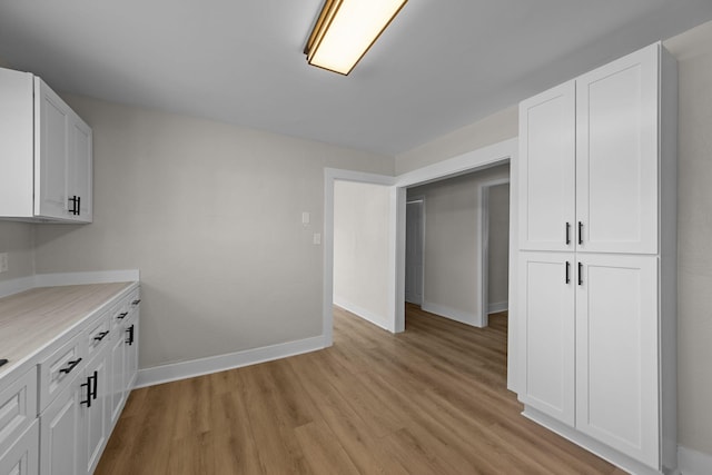 kitchen featuring white cabinets and light hardwood / wood-style floors