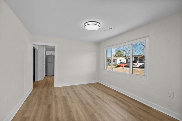 spare room featuring light hardwood / wood-style flooring