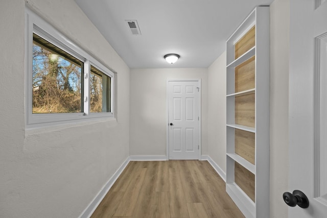 hall with light hardwood / wood-style floors