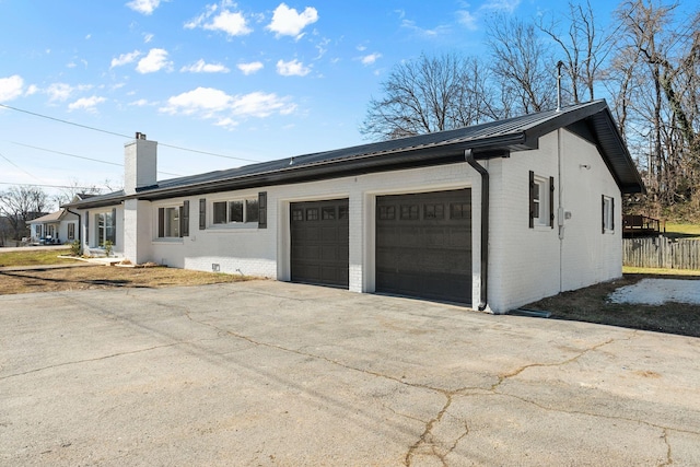 view of side of home featuring a garage