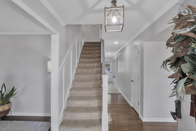 stairway featuring hardwood / wood-style floors and ornamental molding