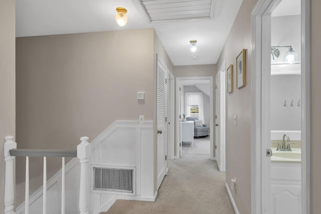 corridor with light colored carpet