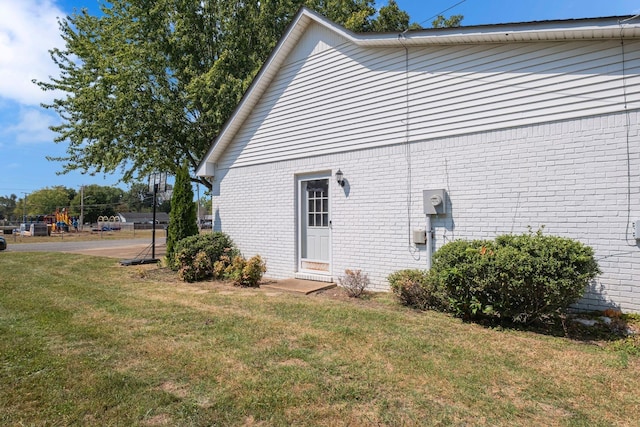 view of side of home with a lawn