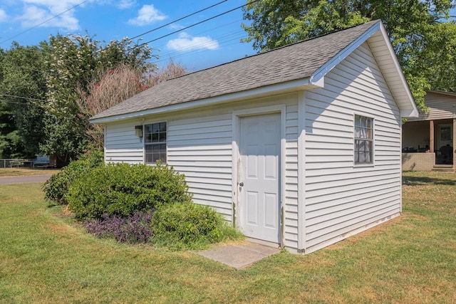 view of outbuilding featuring a lawn